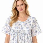 Close-up of blue floral nightdress showing round neckline, short button placket, gathered front and lace trim