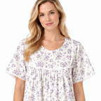 Close-up of lilac floral nightdress showing the round neckline, short button placket, gathers and lace trim
